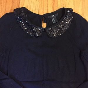 Black sweater with sequin trimm collar. NWOT