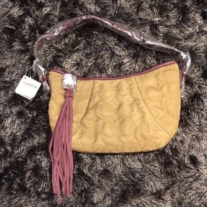 Tan and plum purple Coach handbag