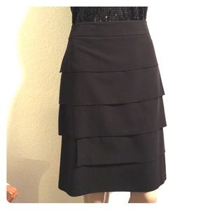 $Sold$ Smooth lying black tier skirt with kick pleat.