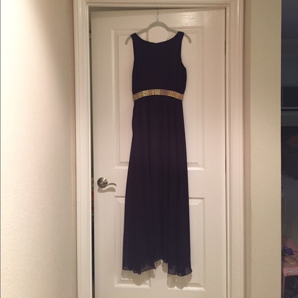 Plum colored long dress with gold trim belt.