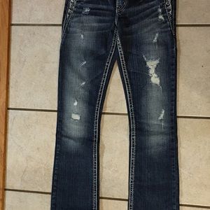 A pair of silver jeans