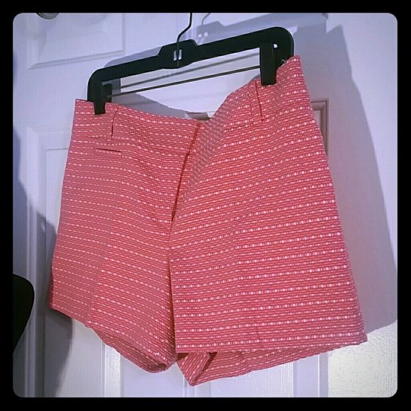 Pink shorts with cream ribbon detail.