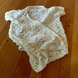 A slightly used Justice crocheted sweater