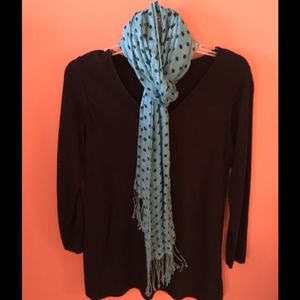 Turquoise scarf with black dots.