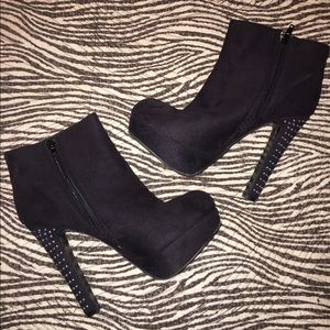 High heel black bootie with studs on heel.