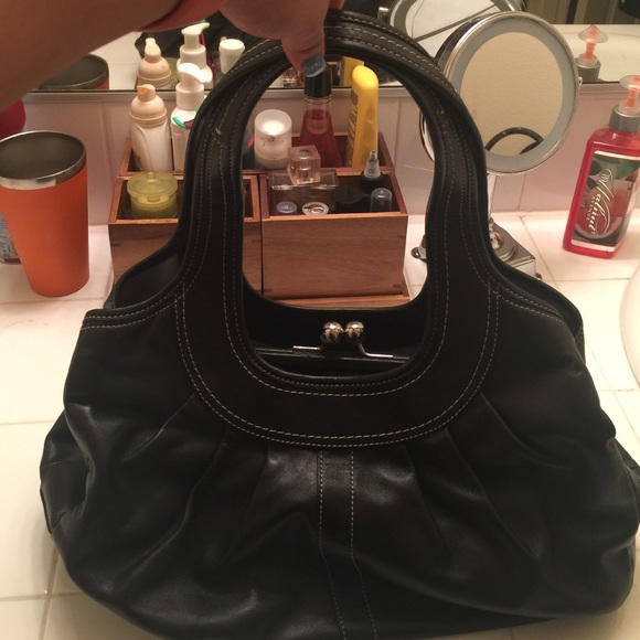 Very unique coach purse with snap middle.