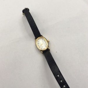 Black leather strapped delicate gold face watch