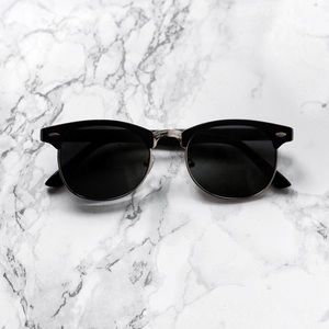 Black and gold framed sunglasses