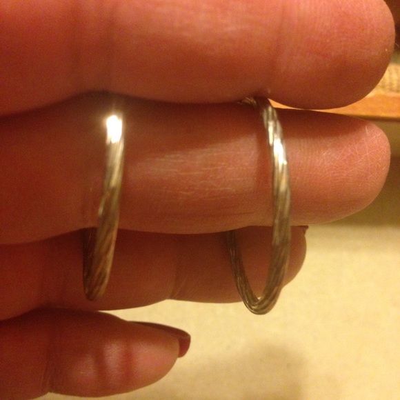 Silver hoop pierced earrings.