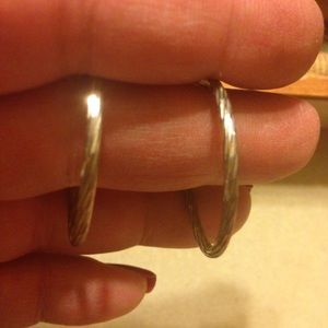Silver hoop pierced earrings.