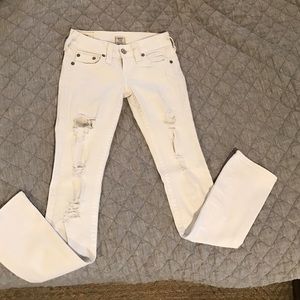 Distressed white jeans