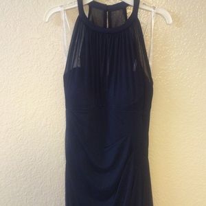 Navy blue floor length high neck dress.