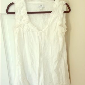 White sleeveless shirt with rosettes on the front