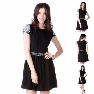 Francesca's black dress with embroidered sleeves