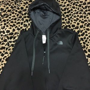Woman's black North Face zip up hoodie.
