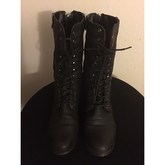 Black laced up combat boots.