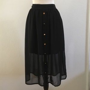 Mid length, black chiffon skirt with gold buttons