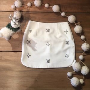 White mini skirt covered in rime stones