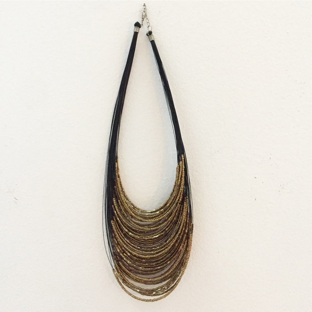 Wire statement necklace with golden beads