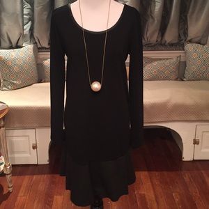 Black dress with vegan leather bottom and trim.