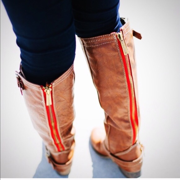 Brown riding boots with red zipper