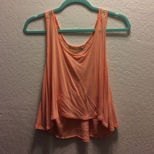 A peachy colored tank top/crop top