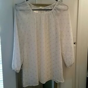 Sheer blouse with light brown circle details.