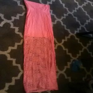 A coral in color short with long lace skirt.