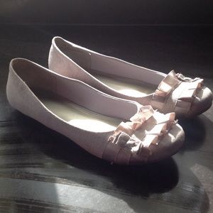 Tan, light khaki flats with ruffle detail at toe