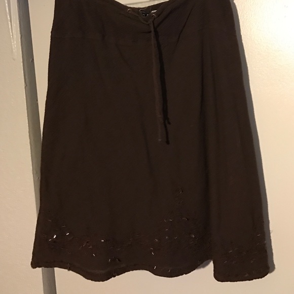 A dark brown skirt with embellishments at bottom - Picture 1 of 2