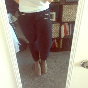 Black stretch pants with front zippers