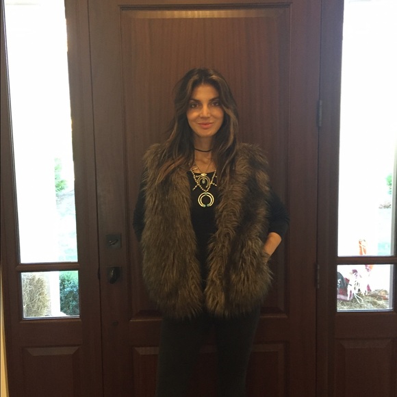 Faux fur vest with 3 hidden closures.