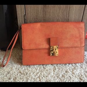 Orange clutch with leopard lining.