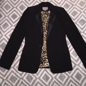 Black blazer with shoulder pads.