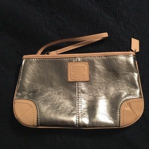 NEW. With care card inside Silver Coach Wristlet
