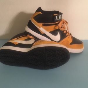 Black and Gold Nike high top shoes