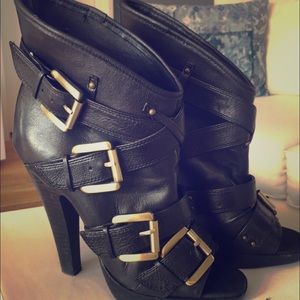 Black peep toe booties with gold buckles