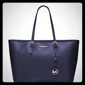 MK jet set travel med. top zip multi function tote