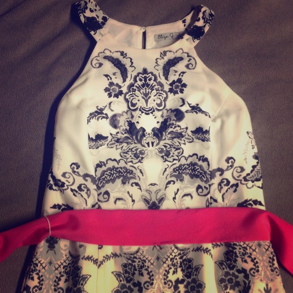 White, with black details and pink sash dress.