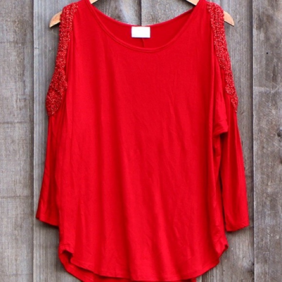 Long sleeved embroidered cut-out shoulder shirt.