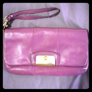 Eggplant purple Coach wristlet.