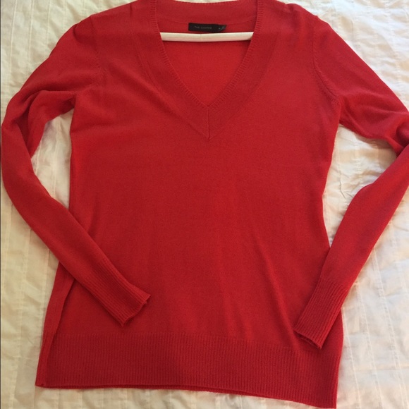 V-neck sweater. It's a light red/pink color.