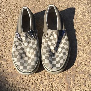Grey and white checkered Vans slip ons