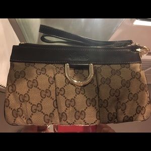 Brown Gucci monogram wristlet