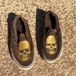 Faded Black Vans slip ons with faded gold skull