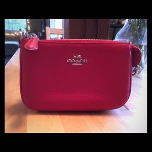Brand new, never used red leather Coach clutch