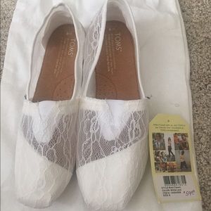 Toms white slip on lacy shoes