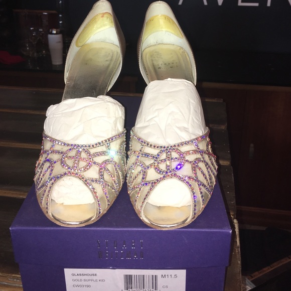 Stuart Weitzman gold pumps with rhinestone accent.
