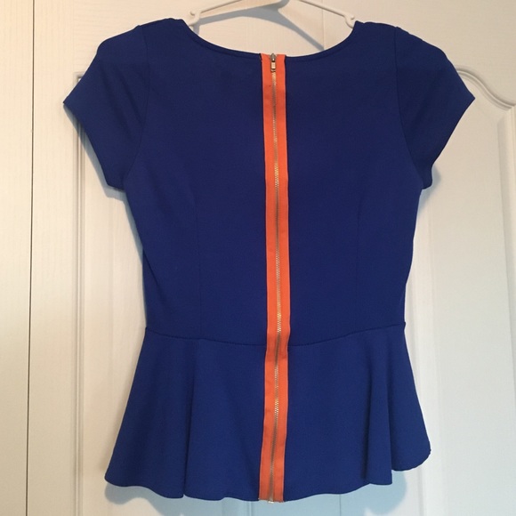 Blue peplum top with orange zipper down back.
