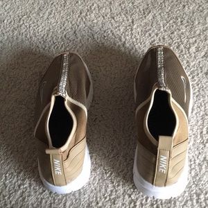 New gold Nike sneaker.